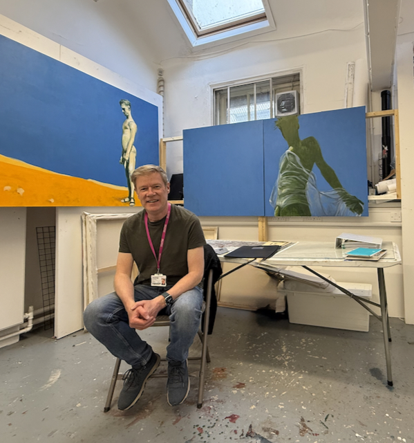 Alan Brash in his Glasgow studio with figurative paintings.